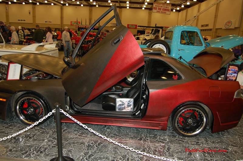 The 2009 World of Wheels Show in Chattanooga, Tennessee. On Jan. 9th,10, & 11th, Pictures by Ron Landry. I believe it is a Nissan, with Lambo doors, a body kit, a two tone paint job with front being matte black it appears, trying to get that murdered out look I guess.
