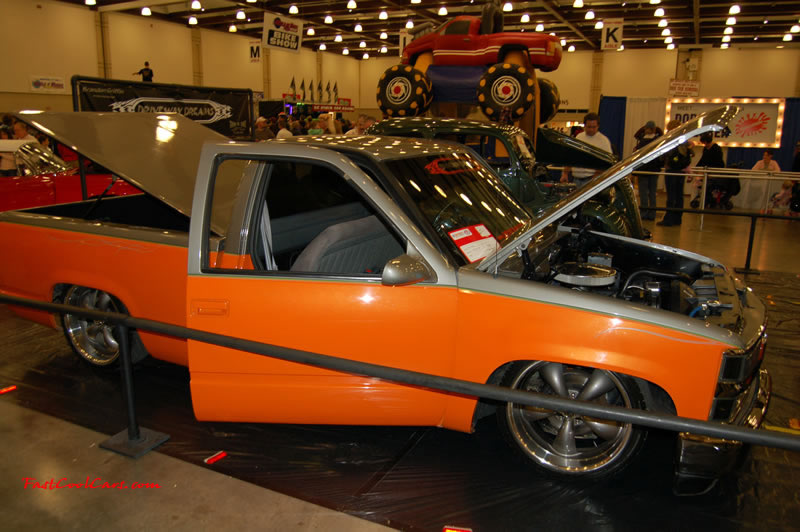 The 2009 World of Wheels Show in Chattanooga, Tennessee. On Jan. 9th,10, & 11th, Pictures by Ron Landry. Low rider Lil' truck with custom rims, and a two tone paint job. Orange and silver.
