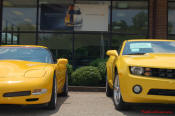 2010 Chevrolet Camaro 2LT and a 2002 supercharged Z06 Corvette, both in Yellow.