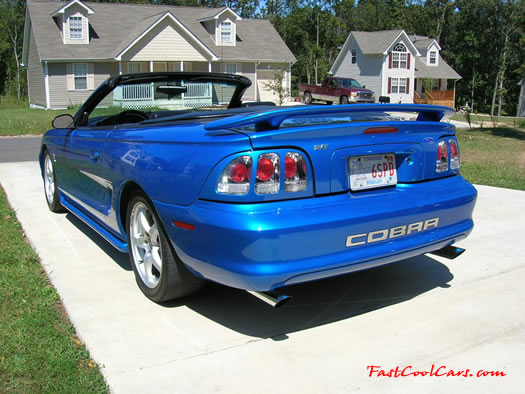 1998 Mustang Cobra Convertible - 1 of 223 - Electric blue, with top down, and shiny mirror finished stainless Cobra letters.