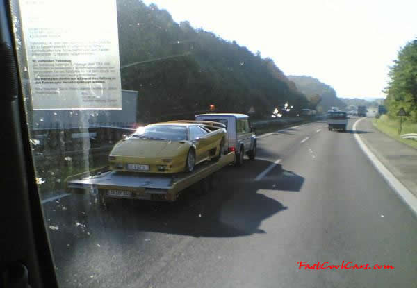 Very Fast Cool Exotic Supercar on a trailer, probably going to a car show.