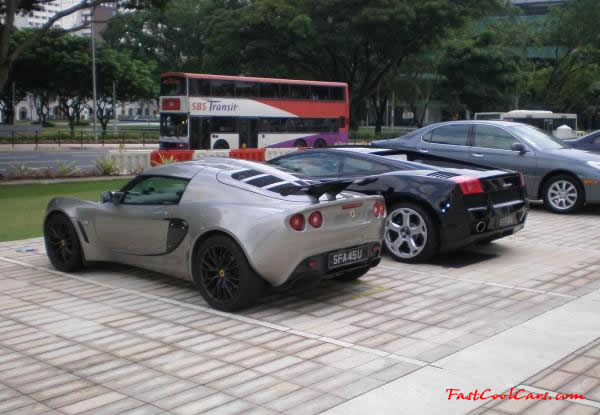 Very Fast Cool Exotic Supercar, a Lotus and a Lamborghini parked next to each other.