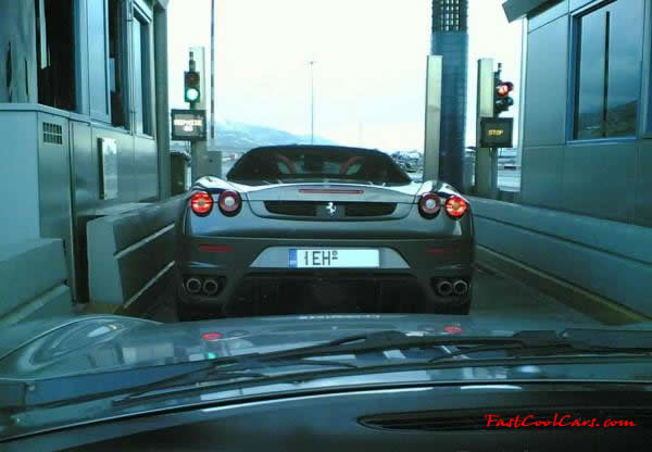 Very Fast Cool Exotic Supercar Ferrari roadster in the toll booth.