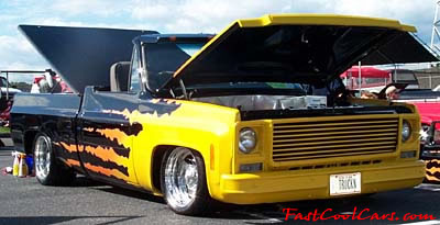 Lowriders that have been lowered, dropped, slammed, and scraping. Highly customized pick up truck.