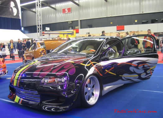 Lowriders that have been lowered, dropped, slammed, and scraping. Nice paint job.