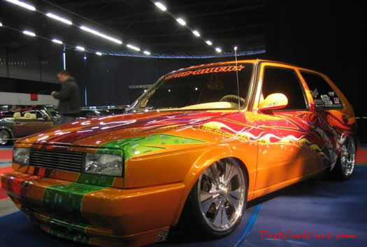 Lowriders that have been lowered, dropped, slammed, and scraping. Cool paint job.