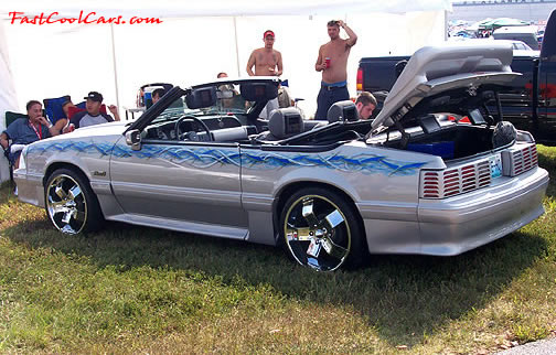 Lowriders that have been lowered, dropped, slammed, and scraping. Lowrider Ford Mustang convertible.