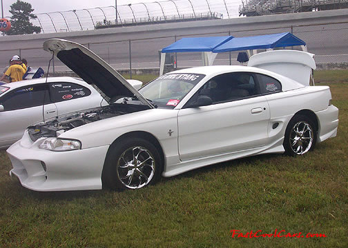 Lowriders that have been lowered, dropped, slammed, and scraping. Lowrider Ford Mustang, with body kit.