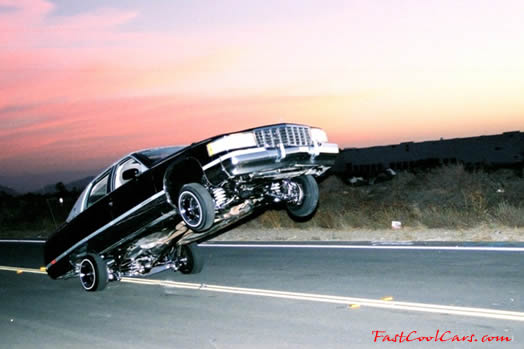 Lowriders that have been lowered, dropped, slammed, and scraping, using many different modifications. getting some air