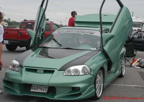 Lowriders that have been lowered, dropped, slammed, and scraping, modified doors.