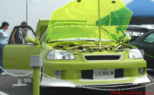 Lowriders that have been lowered, dropped, slammed, and scraping. Nice see-thru hood.