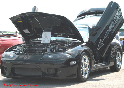 Lowriders that have been lowered, dropped, slammed, and scraping. Nice gull-winged doors.