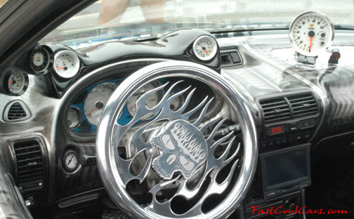 Lowriders that have been lowered, dropped, slammed, and scraping. Check out the steering wheel on that car.